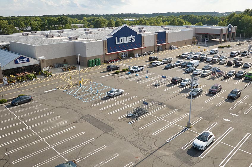 Image of Brunswick Commons shopping center with various shops and parking spaces.