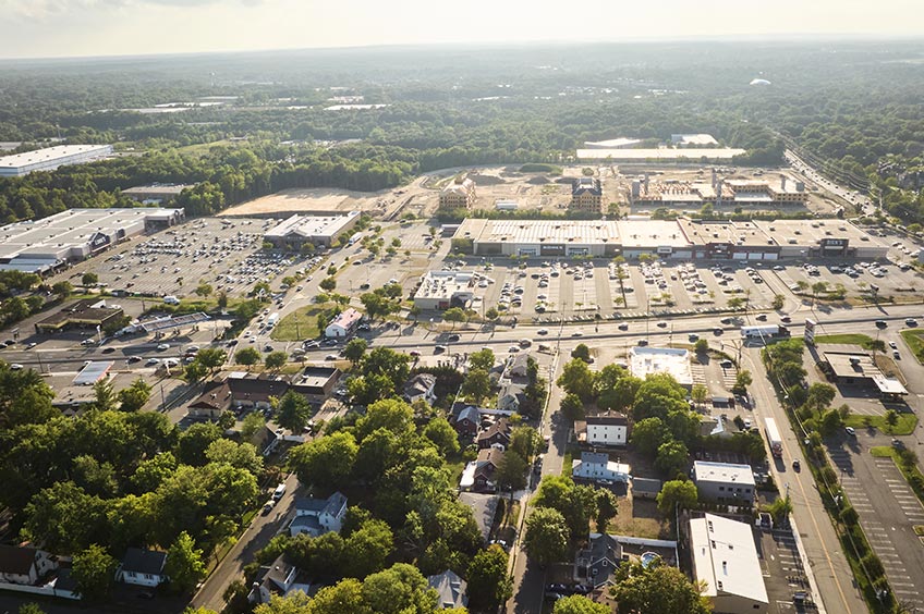 Overhead shot of Brunswick Commons shopping center and its adjacent parking lot, captured from a high vantage point.