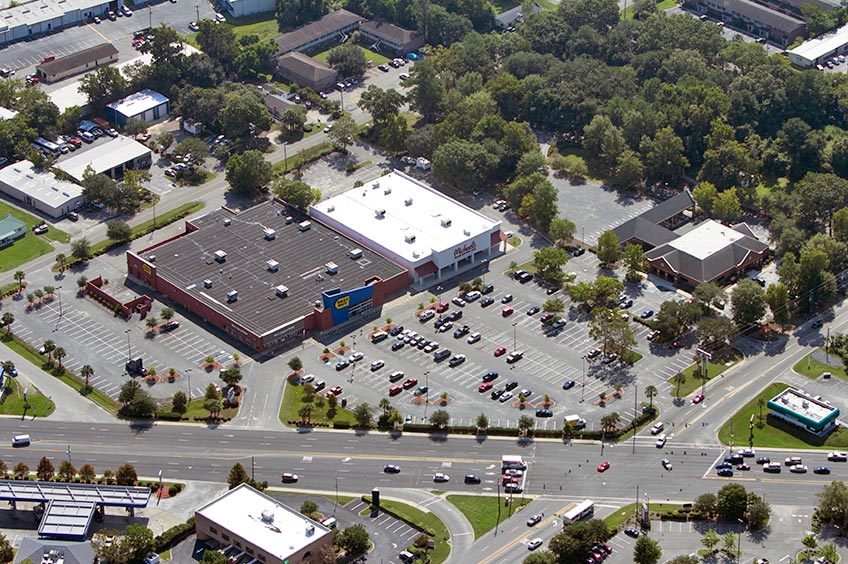 Overhead shot of Charleston shopping center and its adjacent parking lot, captured from a high vantage point.