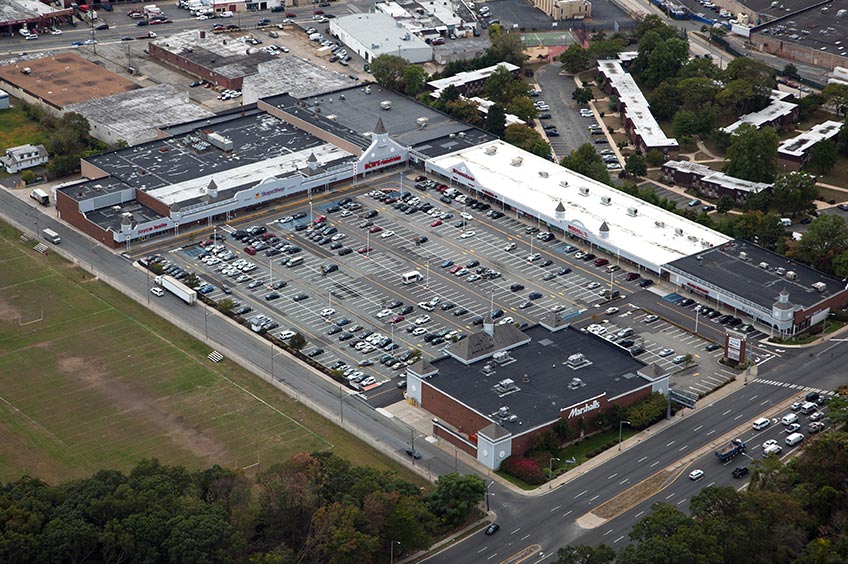 Overhead shot of Freeport (Meadowbrook Commons) shopping center and its adjacent parking lot, captured from a high vantage point.