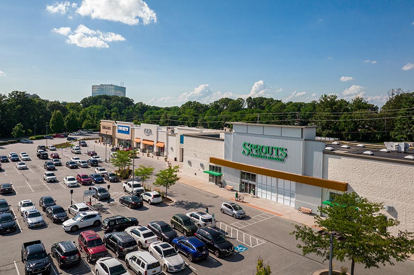 Goucher Commons shopping center with various shops and parking spaces.