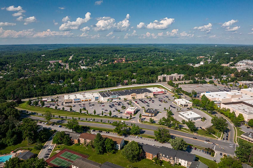 Aerial view of Goucher Commons shopping center and its adjacent parking lot, captured from a high vantage point.