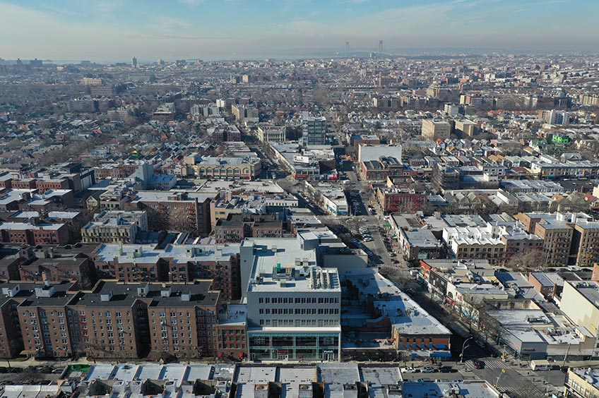 Aerial view of Kingswood Crossing shopping center and its adjacent parking lot, captured from a high vantage point.