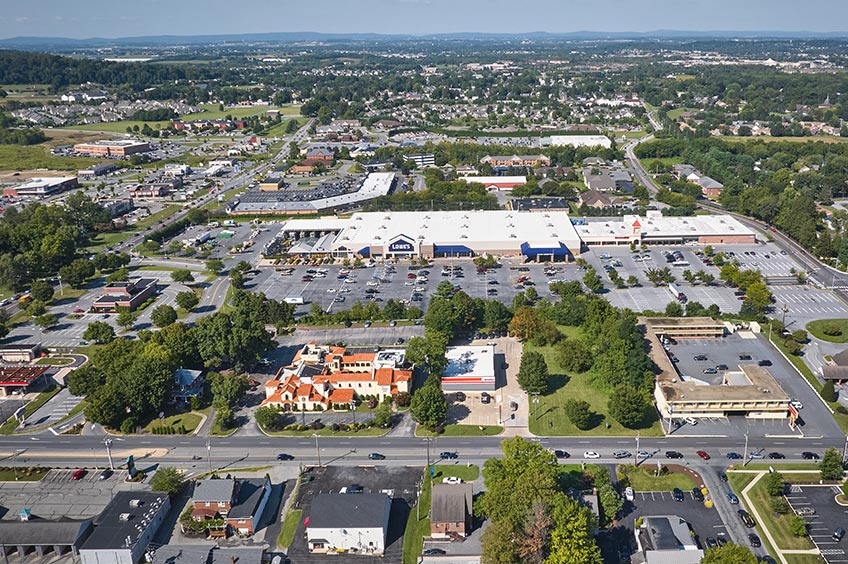 Aerial view of Lincoln Plaza shopping center and its adjacent parking lot, captured from a high vantage point.