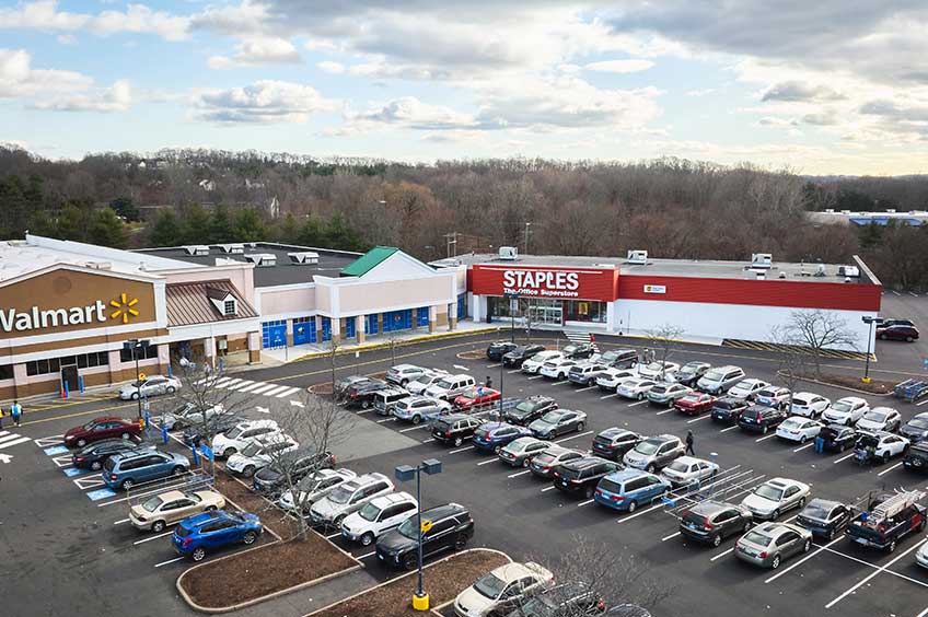 Image of Newington Commons shopping center with various shops and parking spaces.