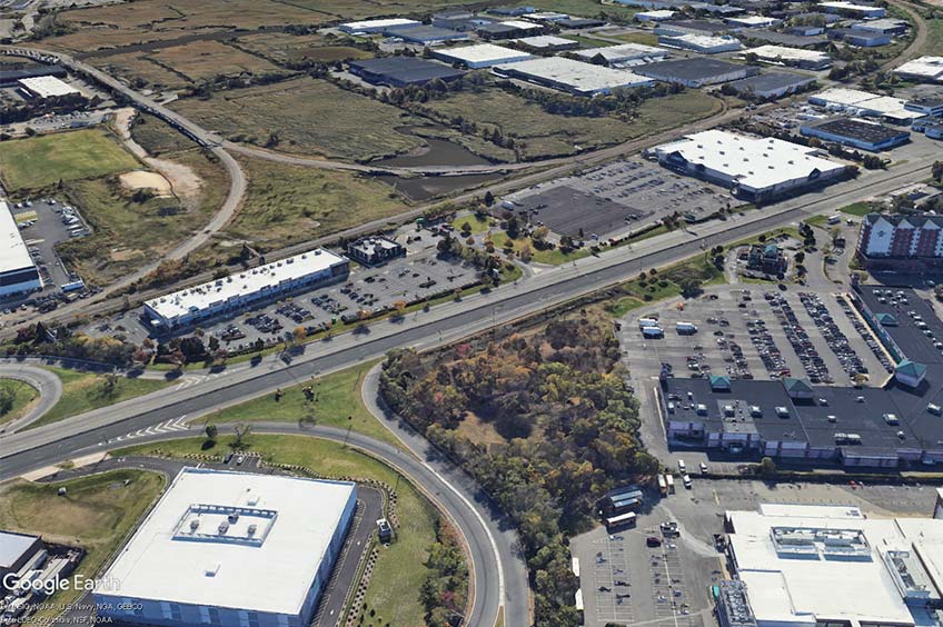 Aerial view of Rutherford Commons shopping center and its adjacent parking lot, captured from a high vantage point.