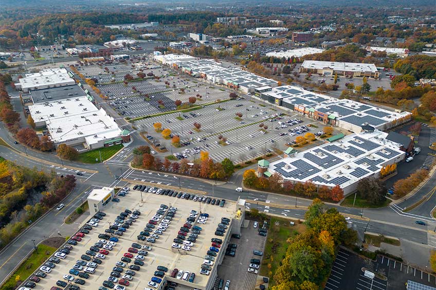 Aerial view of Shoppers World center and its adjacent parking lot, captured from a high vantage point.