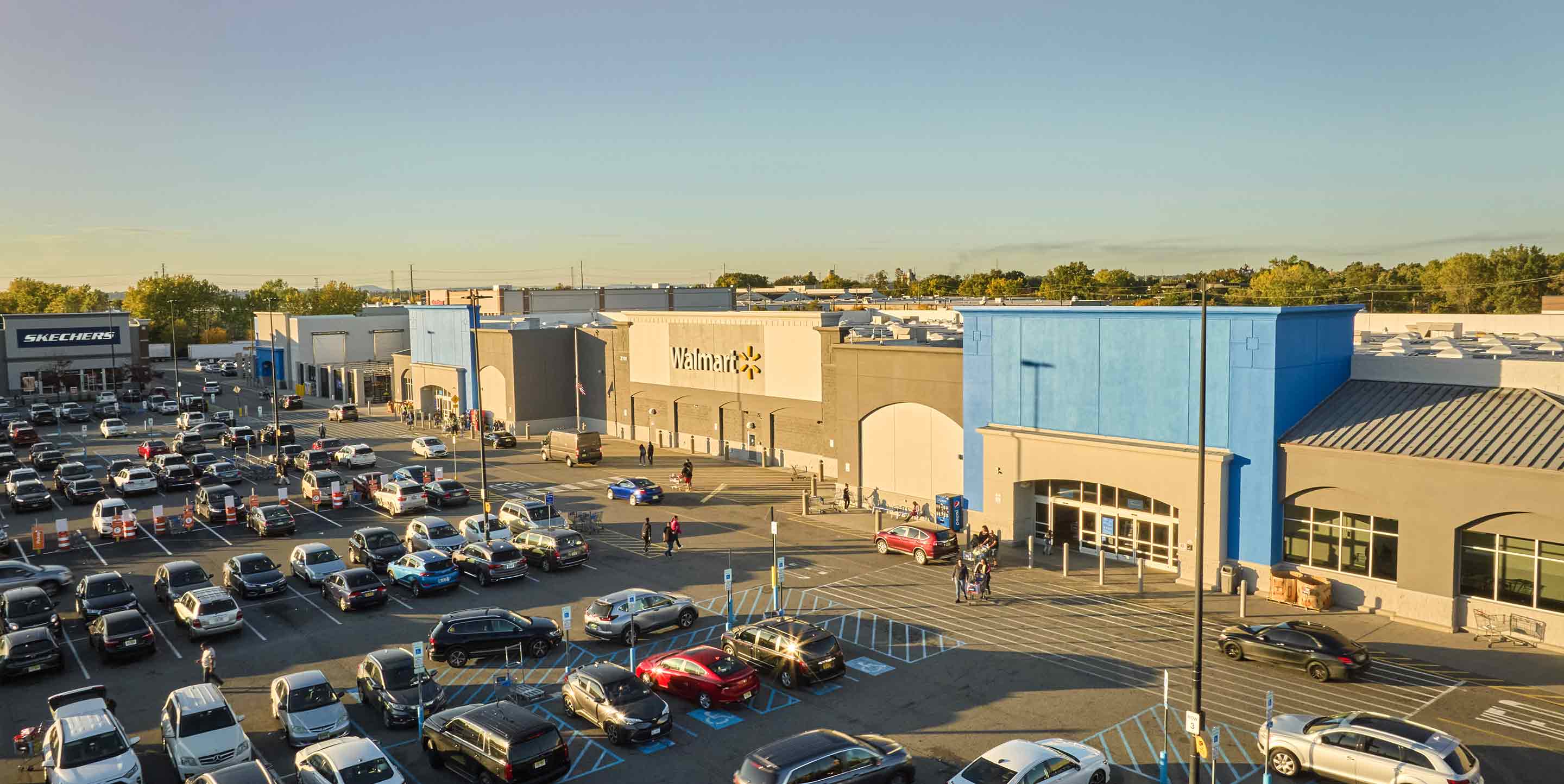 Image of Tonnelle Commons shopping center with various shops and parking spaces.