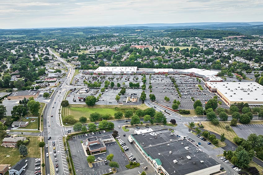 Aerial shot of Wyomissing shopping center and its adjacent parking lot, captured from a high vantage point.