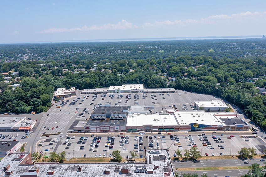 Overhead shot of Yonkers Gateway Center shopping center and its adjacent parking lot, captured from a high vantage point.